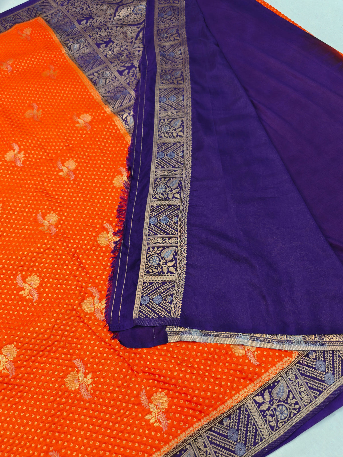 KHADDI GEORGETTE IN TANGY ORANGE WITH INDIGO BORDER